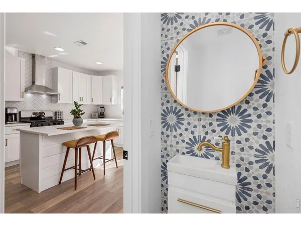 a kitchen with stainless steel appliances granite countertop a white stove and a white refrigerator
