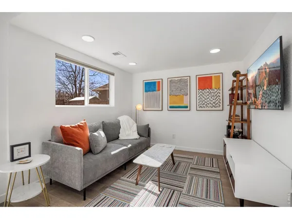 a living room with furniture and wall painting