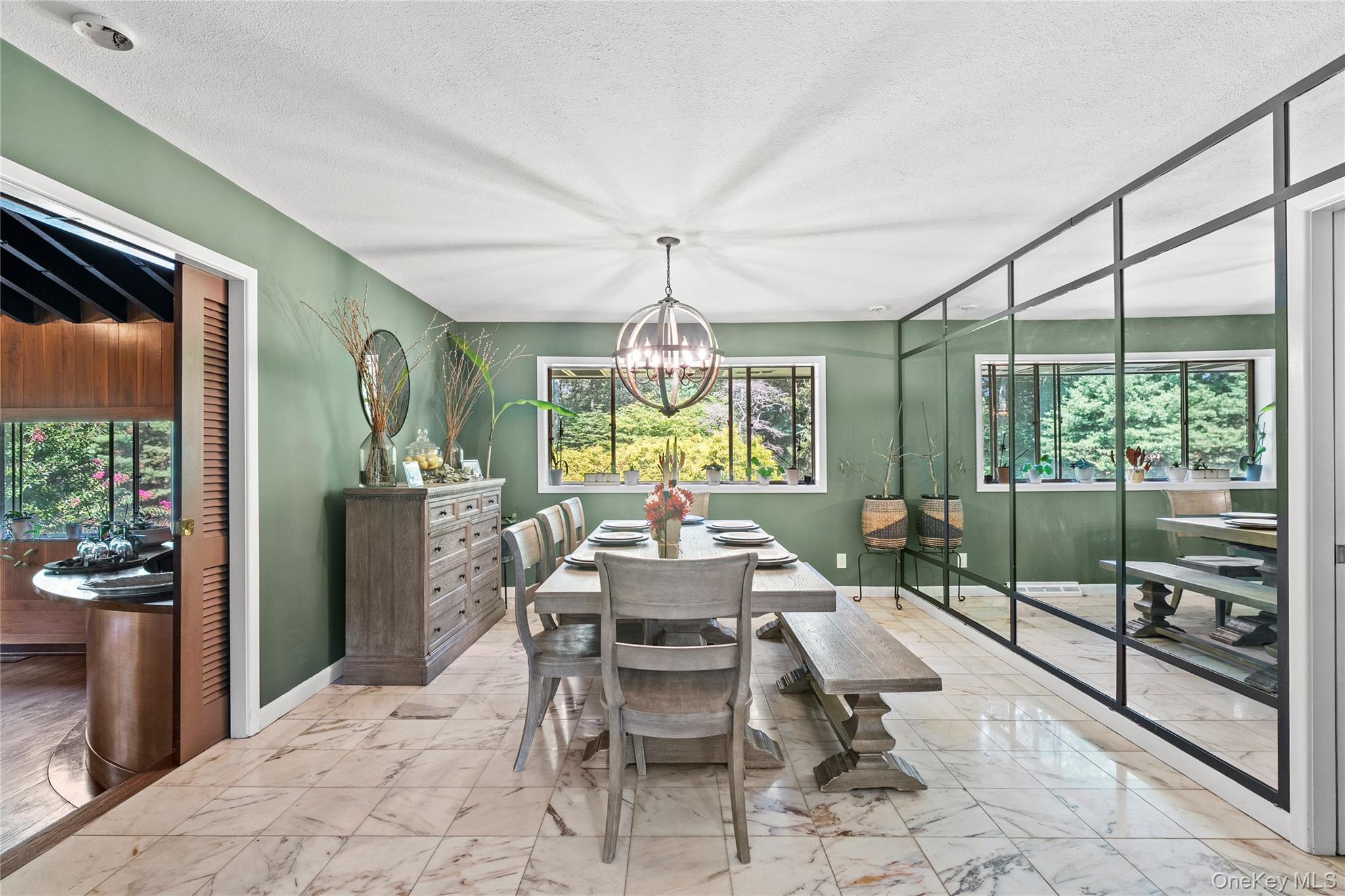55 Rolling Hill Lane Old Westbury, NY 11568 - Photo 13 of 48 Dining room with marble finish flooring, plenty of natural light, a textured ceiling, and a chandelier