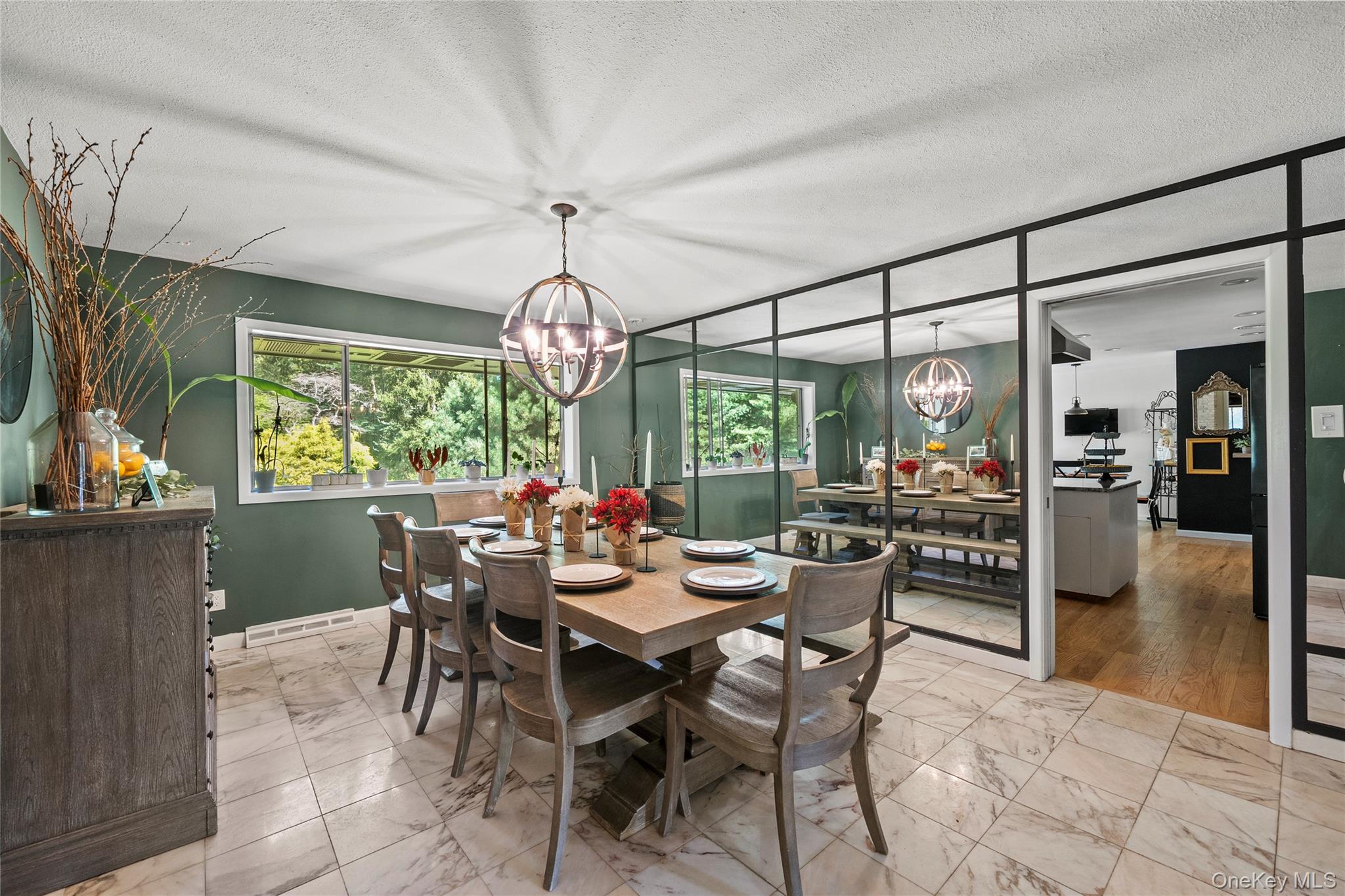 55 Rolling Hill Lane Old Westbury, NY 11568 - Photo 15 of 48 Dining area with a textured ceiling, light marble finish floors, and a chandelier