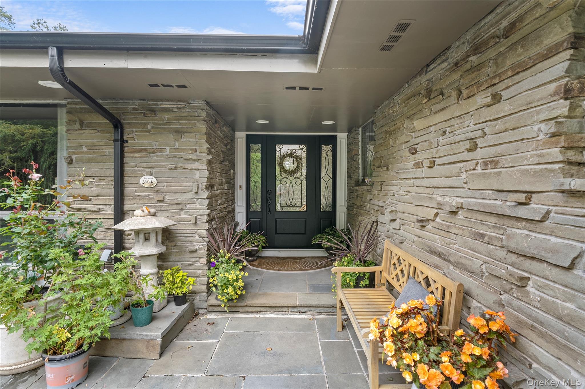 55 Rolling Hill Lane Old Westbury, NY 11568 - Photo 2 of 48 Property entrance featuring stone siding and covered porch