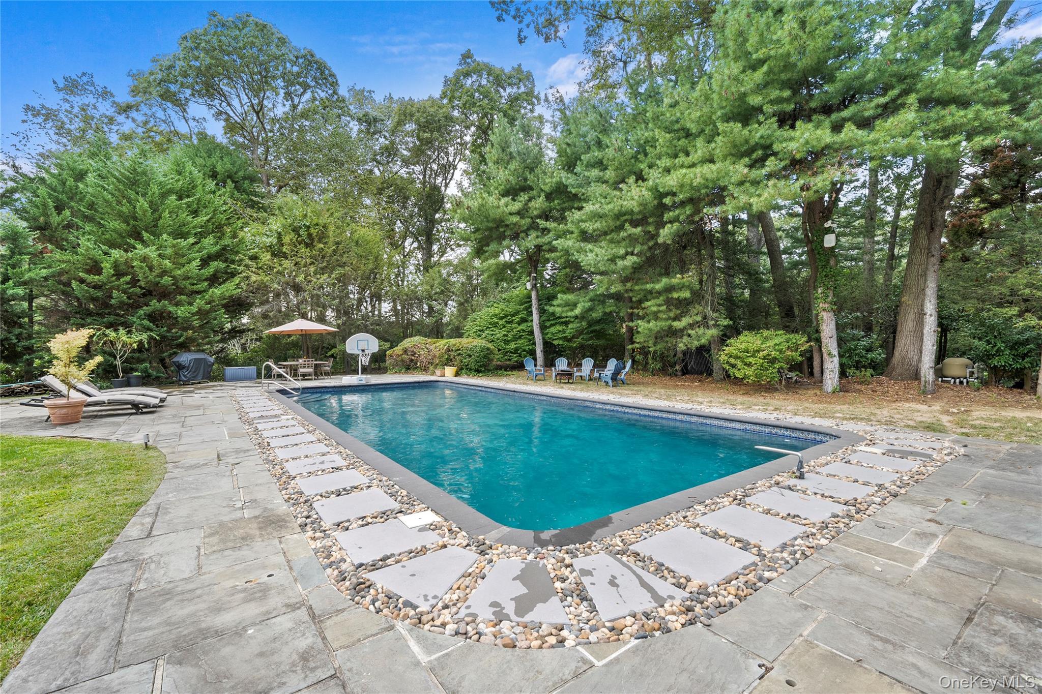55 Rolling Hill Lane Old Westbury, NY 11568 - Photo 39 of 48 Swimming pool featuring a patio area and view of scattered trees