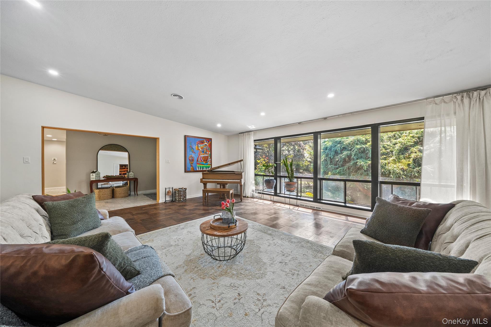 55 Rolling Hill Lane Old Westbury, NY 11568 - Photo 7 of 48 Living room featuring vaulted ceiling, recessed lighting, arched walkways, and parquet floors