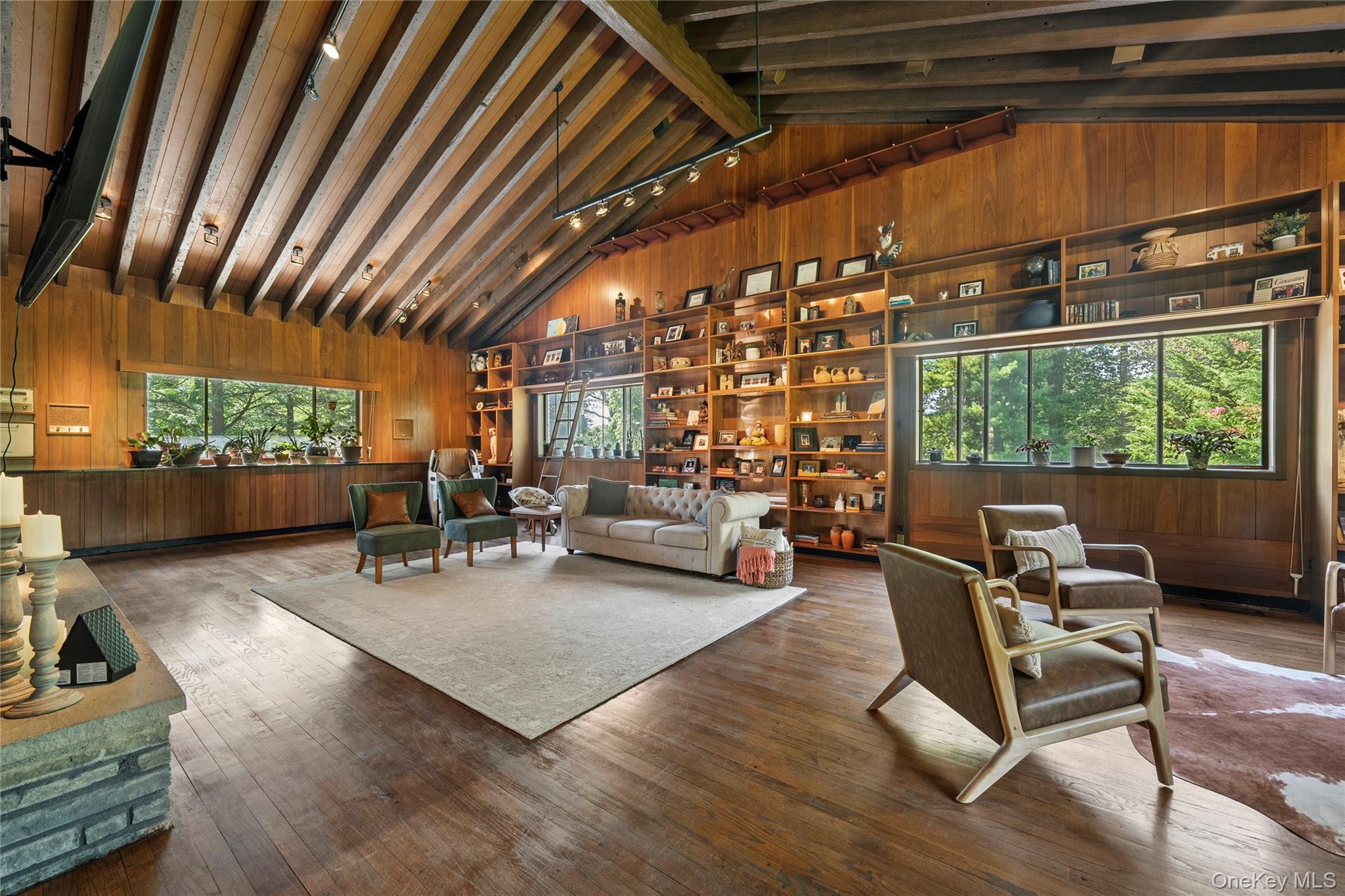 55 Rolling Hill Lane Old Westbury, NY 11568 - Photo 9 of 48 Living area featuring wood walls, wood-type flooring, beamed ceiling, and high vaulted ceiling