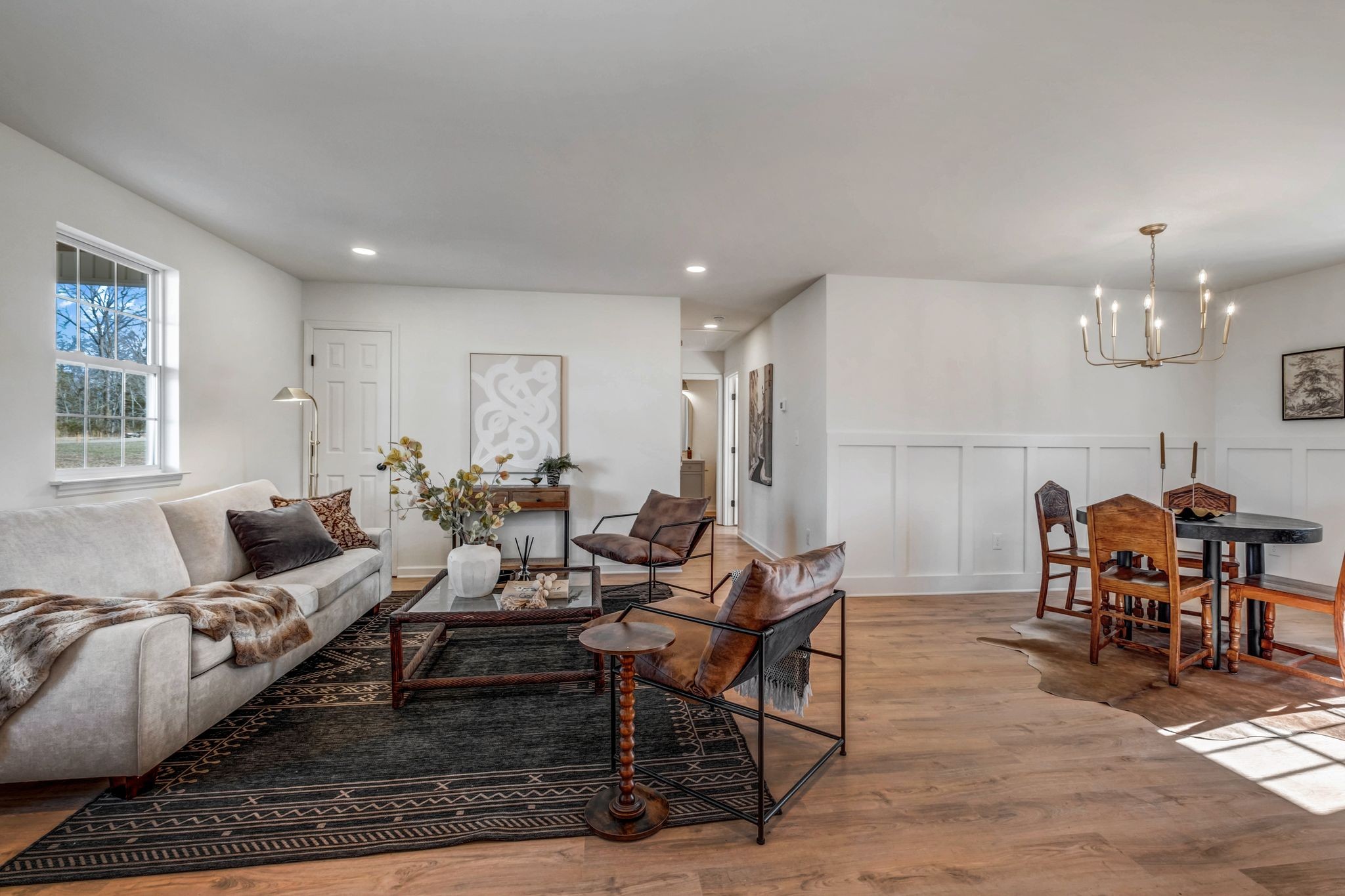 2308 Rogers Lane Lebanon, TN 37087 - Photo 19 of 36 a living room with furniture a dining table and a chandelier
