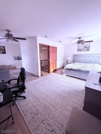 a living room with a bed furniture and a window