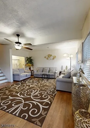a living room with furniture and a rug