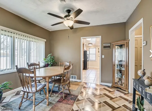 a view of a dining room with furniture and a chandelier