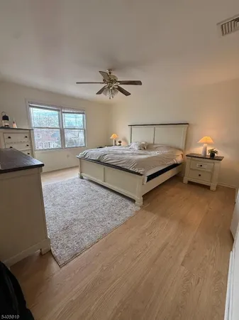 a spacious bedroom with a bed and window