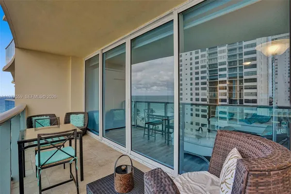 a view of a balcony with chair and table