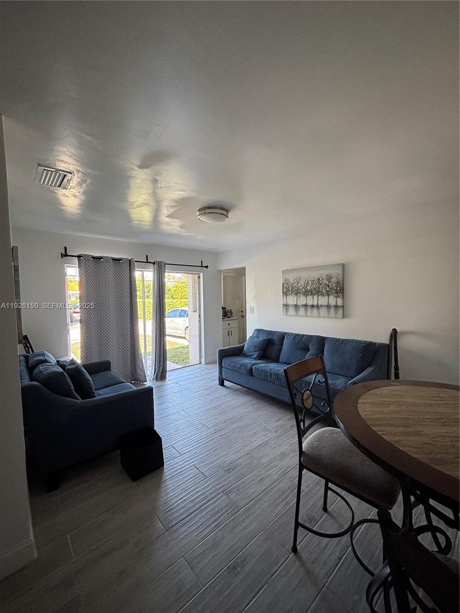 4807 Ponce De Leon, Unit 1 Coral Gables, FL 33146 - Photo 1 of 8 a living room with furniture and a table