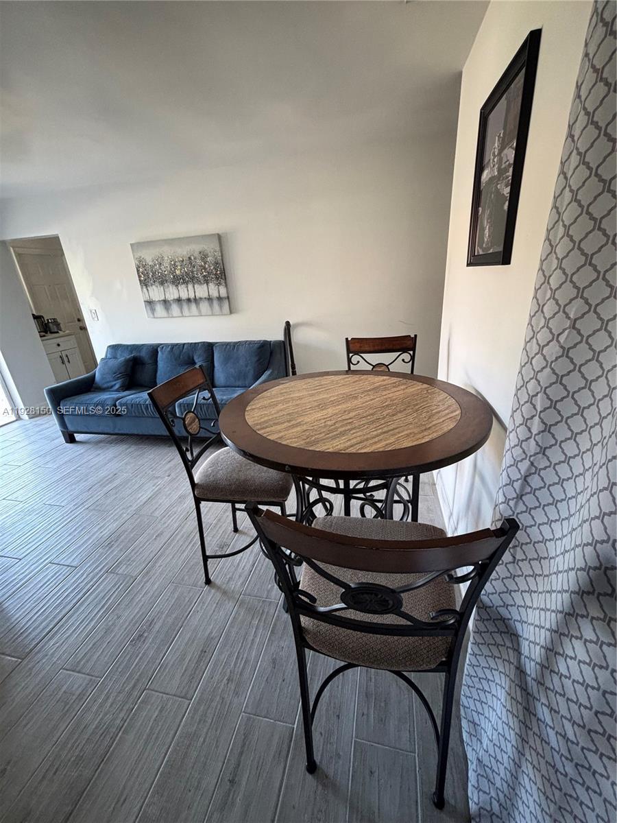 4807 Ponce De Leon, Unit 1 Coral Gables, FL 33146 - Photo 2 of 8 a living room with furniture and a wooden floor
