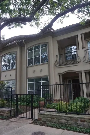 a view of a brick house with large windows