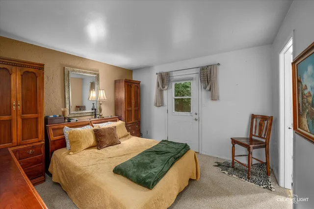 a bedroom with a bed and a painting on the wall