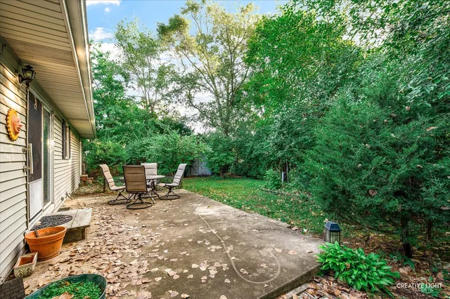 a view of chair and tables in the backyard of the house