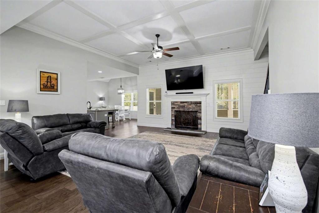 92 Gordon Oaks Way Moreland, GA 30259 - Photo 11 of 54 a living room with furniture a fireplace and a flat screen tv