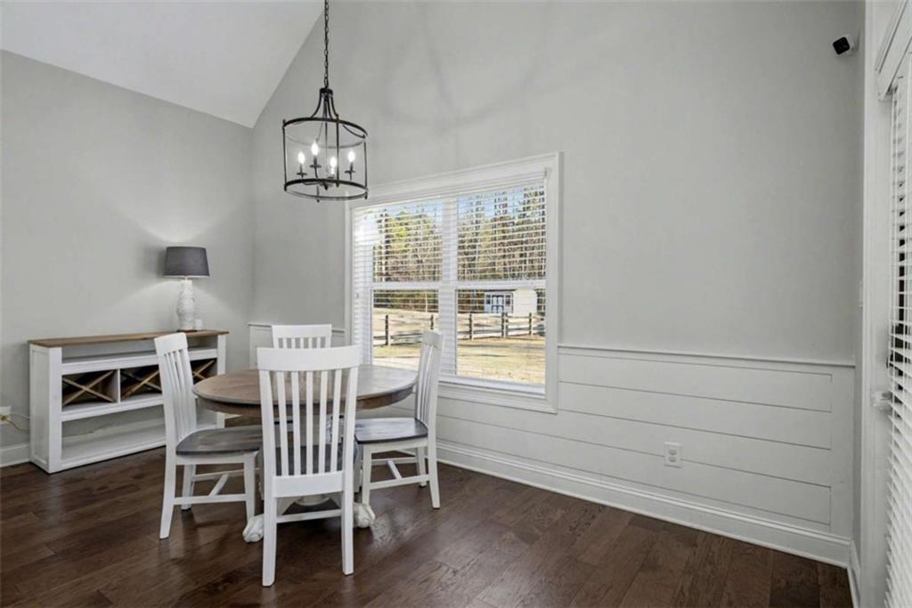 92 Gordon Oaks Way Moreland, GA 30259 - Photo 18 of 54 a dining room with wooden floor a chandelier a wooden table and chairs