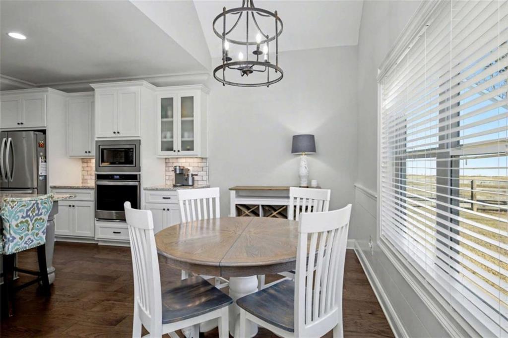 92 Gordon Oaks Way Moreland, GA 30259 - Photo 19 of 54 a view of a dining room with furniture a chandelier and wooden floor