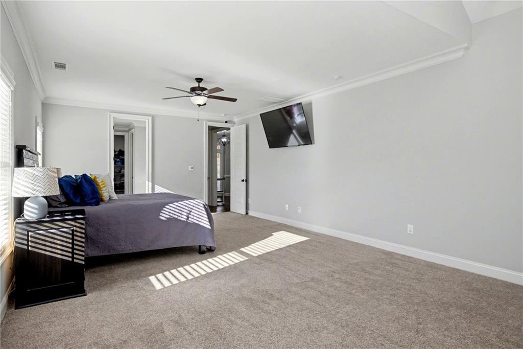 92 Gordon Oaks Way Moreland, GA 30259 - Photo 20 of 54 a bedroom with a bed chandelier and a window