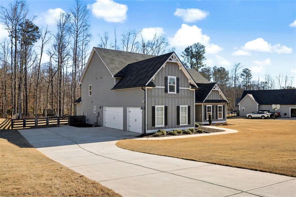 92 Gordon Oaks Way Moreland, GA 30259 - Photo 2 of 54 a front view of a house with a yard and garage