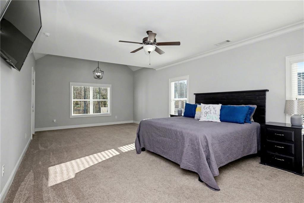 92 Gordon Oaks Way Moreland, GA 30259 - Photo 23 of 54 a spacious bedroom with a bed a window and flat screen tv