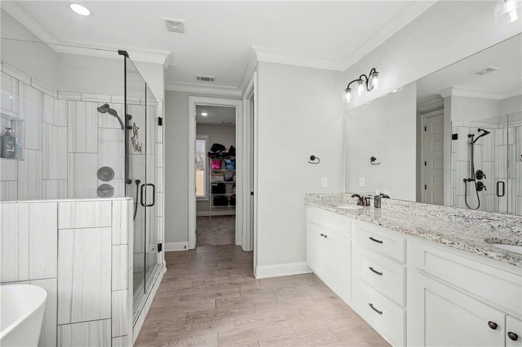 92 Gordon Oaks Way Moreland, GA 30259 - Photo 26 of 54 a spacious bathroom with a granite countertop sink mirror and shower