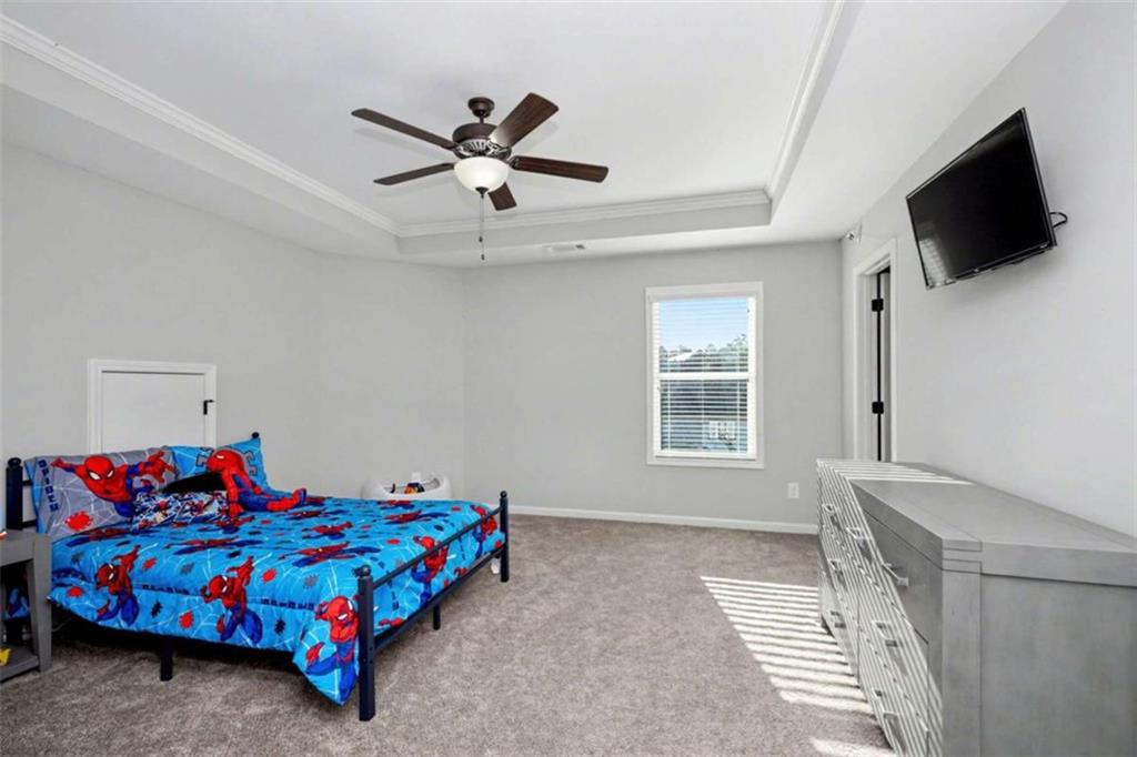 92 Gordon Oaks Way Moreland, GA 30259 - Photo 28 of 54 a bedroom with a bed and a flat screen tv