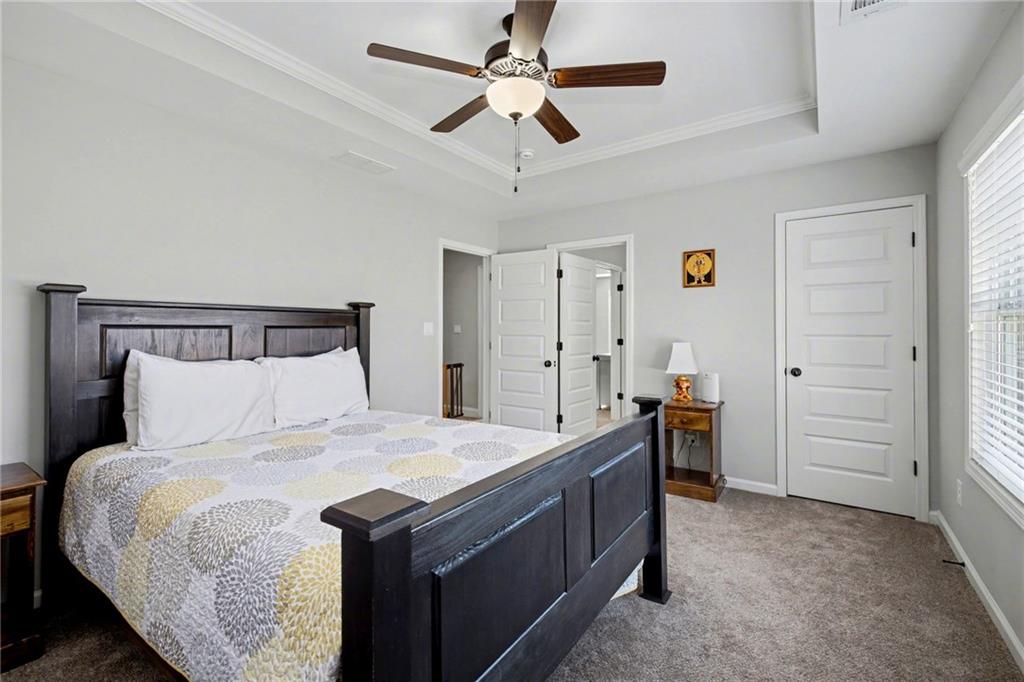 92 Gordon Oaks Way Moreland, GA 30259 - Photo 36 of 54 a bedroom with a bed and a chandelier