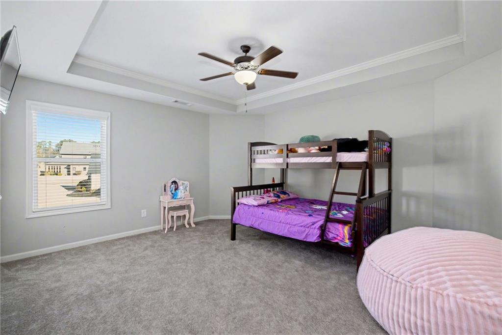 92 Gordon Oaks Way Moreland, GA 30259 - Photo 39 of 54 a bedroom with a bed and a chandelier