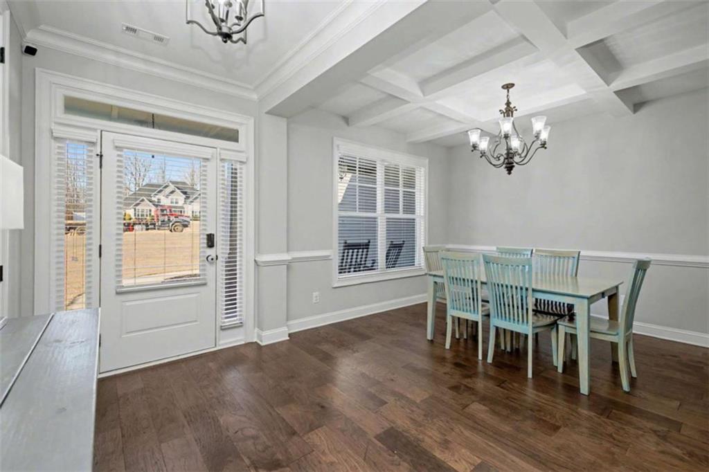 92 Gordon Oaks Way Moreland, GA 30259 - Photo 5 of 54 a dining room with wooden floor a chandelier a glass table and chairs