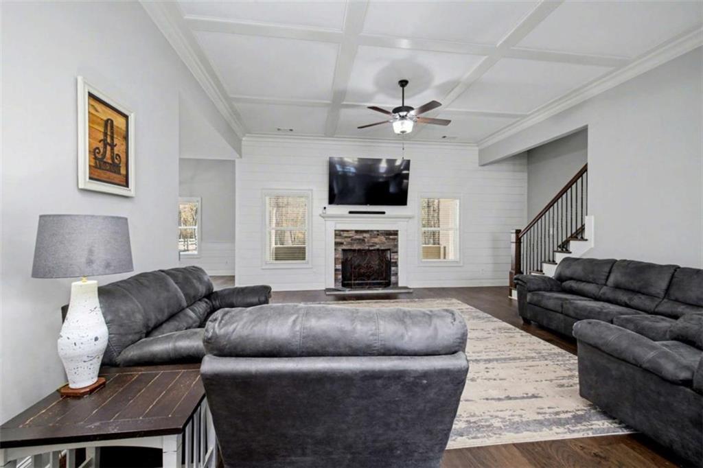 92 Gordon Oaks Way Moreland, GA 30259 - Photo 9 of 54 a living room with furniture a flat screen tv and a fireplace