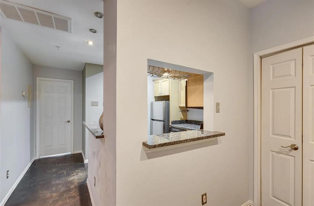 4104 North Hall Street, Unit 102 Dallas, TX 75219 - Photo 17 of 18 Pass-through kitchen window with granite countertop