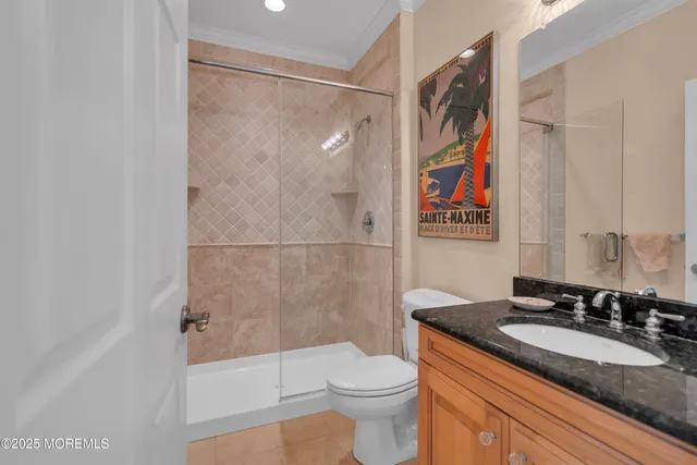 a bathroom with a granite countertop sink toilet and shower