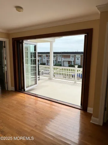 a view of a balcony with wooden floor and fence