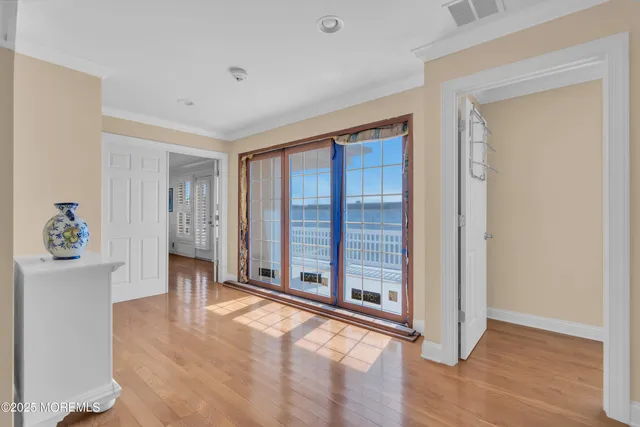 a view of entryway with furniture and wooden floor