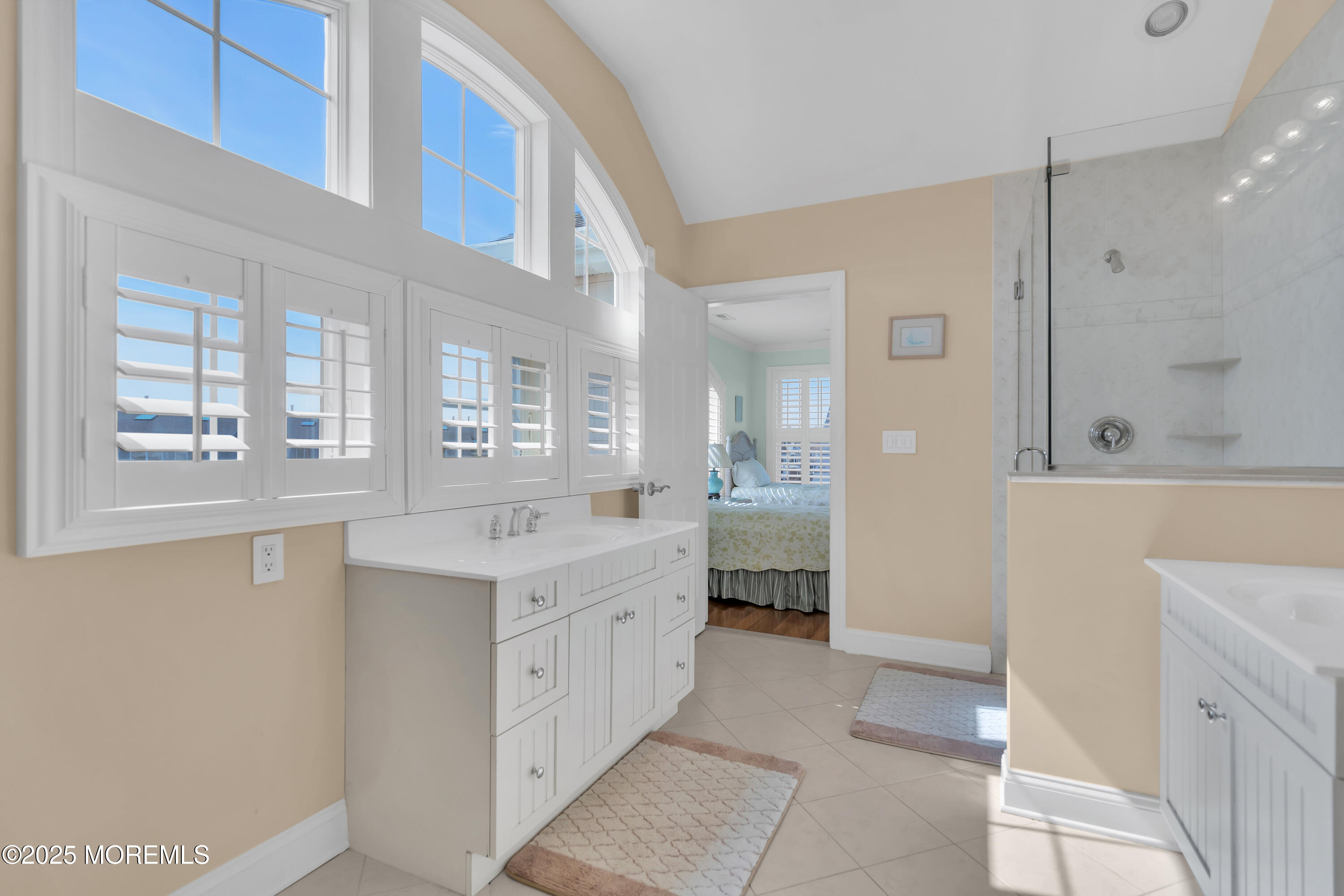 106 2nd Avenue Belmar, NJ 07719 - Photo 33 of 42 a bathroom with a double vanity sink a mirror and a shower