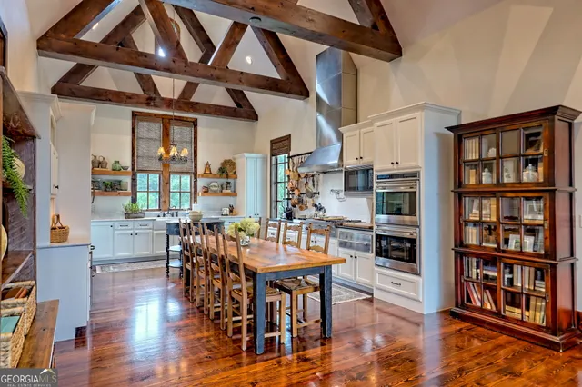 a view of an outdoor dining space with furniture window and outside view