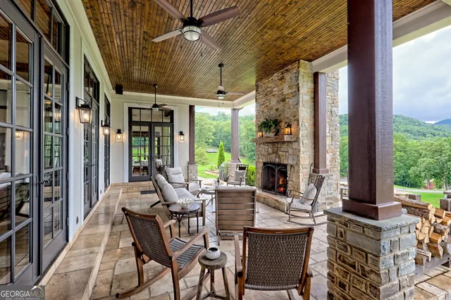a living room with furniture a ceiling fan and a rug