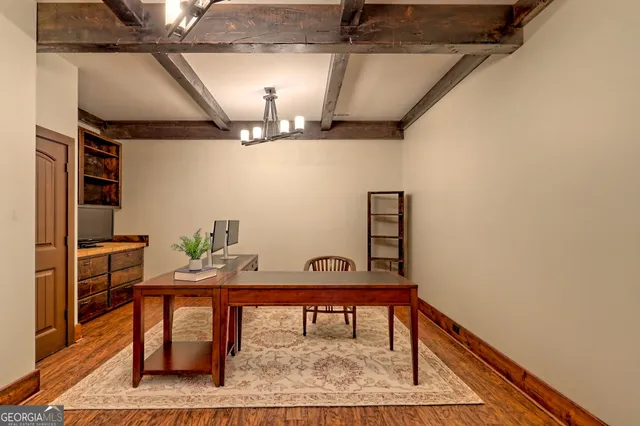 a bedroom with a bed and large windows