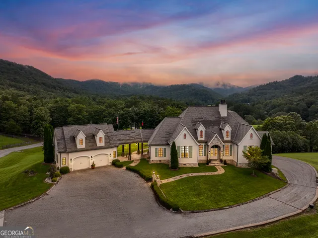 a living room with fireplace furniture and a large window