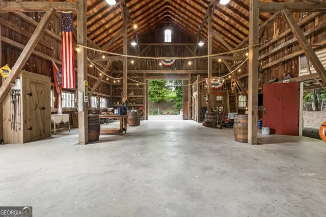 a view of a big house with a big yard and large trees