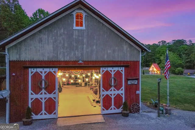 a front view of house with yard and trees in the background