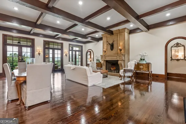a living room with furniture fireplace and wooden floor