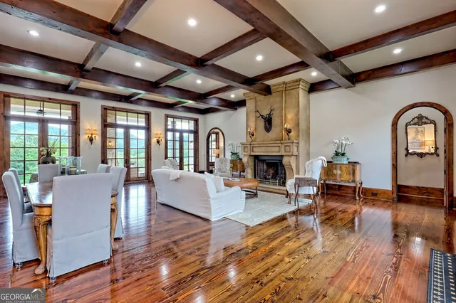 a view of a dining room with a fireplace and large windows