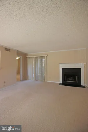 a view of empty room with a fireplace