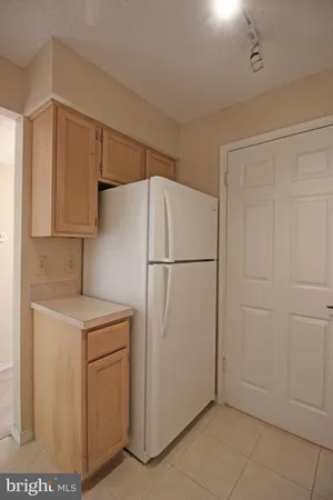 a utility room with cabinets washer and dryer
