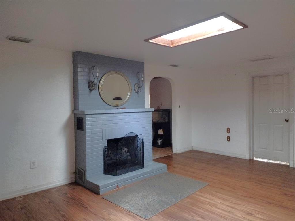 651 Old Haw Creek Road Bunnell, FL 32110 - Photo 2 of 28 a living room with a fireplace and a fireplace