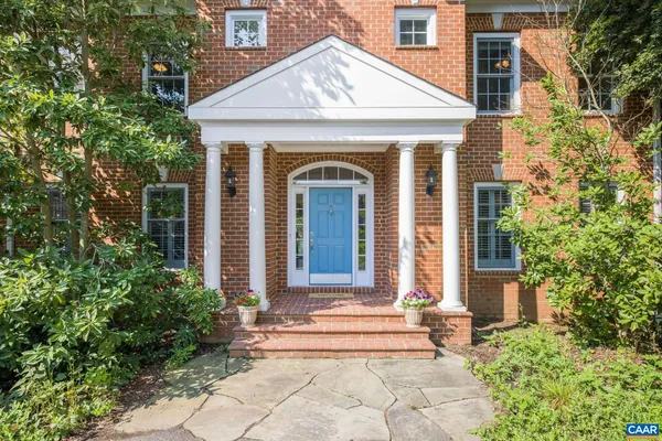 a view of an entryway with wooden floor and door