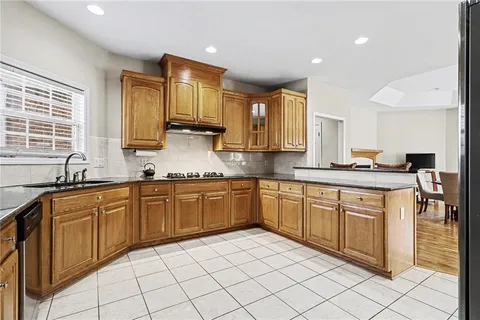a kitchen with stainless steel appliances granite countertop a sink and cabinets