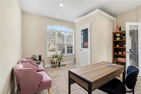 a living room with furniture a table and a large window